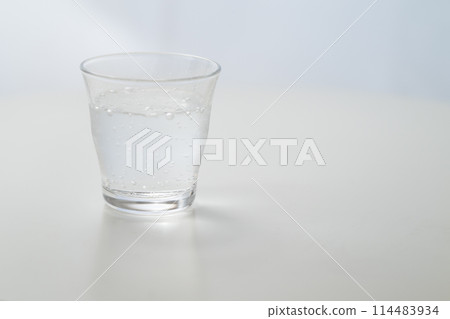 Glass of carbonated water by the window Glass of carbonated water by the window 114483934