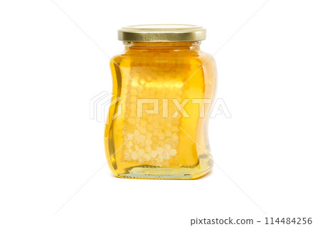 Glass jar filled with honey and honeycomb isolated on white Glass jar filled with honey and honeycomb isolated on white 114484256