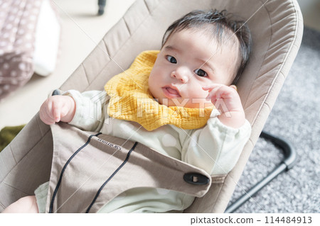 Baby riding a bouncer 114484913