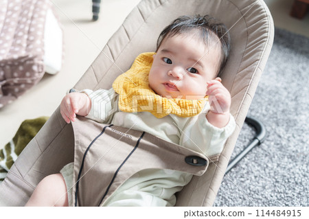 Baby riding a bouncer 114484915