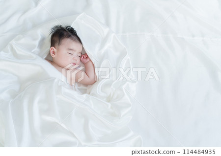 Naked baby taking a nap 114484935