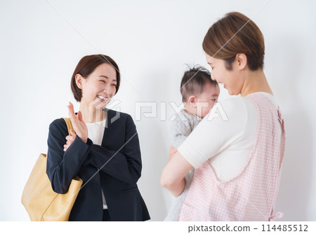 A mother leaving her baby at a nursery school 114485512
