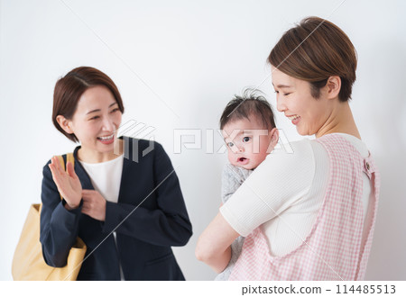 A mother leaving her baby at a nursery school A mother leaving her baby at a nursery school 114485513
