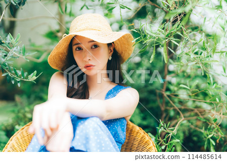 Young woman in resort outfit Young woman in resort outfit 114485614