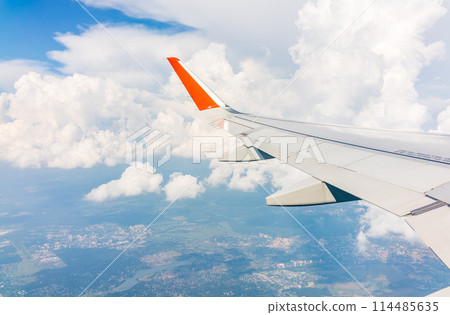View from the airplane window during taking off on a clear summer morning View from the airplane window during taking off on a clear summer morning 114485635