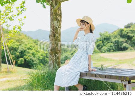Cute woman relaxing in nature Cute woman relaxing in nature 114486215