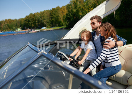 father with adorable daughter and wife resting on big boat father with adorable daughter and wife resting on big boat 114486561