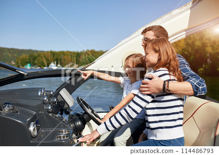 father with adorable daughter and wife resting on big boat 114486793