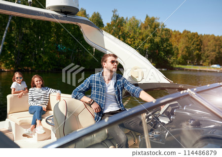 father with adorable daughter and wife resting on big boat 114486879