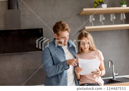 clever guy is helping his girl to prepare for an exam clever guy is helping his girl to prepare for an exam 114487531