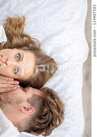 scared girl closing her mouth with a hand while her boyfriend is talking about accident 114487583
