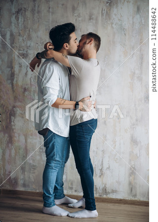 Cay couple enjoy togetherness indoors, kiss each other 114488642