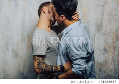 Cay couple enjoy togetherness indoors, kiss each other 114488647