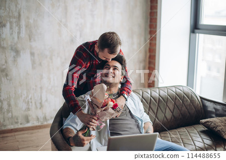 Romantic homo man presenting flowers to his beloved partner, Valentine's Day 114488655