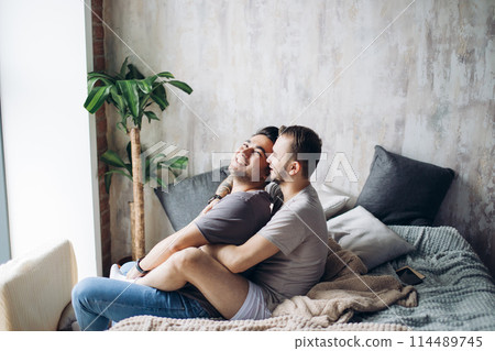 Two sexy caucasian gay guys hugging and having fun in bed indoors 114489745