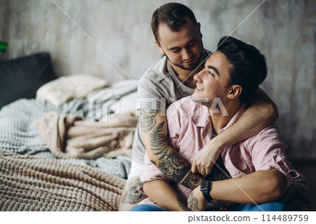 Two sexy caucasian gay guys hugging and having fun in bed indoors Two sexy caucasian gay guys hugging and having fun in bed indoors 114489759