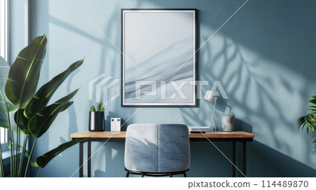 Empty picture frame mockup. A vertical wall art poster hanging on a wall above a desk. Empty picture frame mockup. A vertical wall art poster hanging on a wall above a desk. 114489870