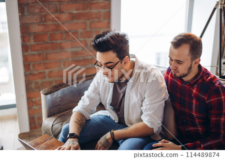 Homosexual partners working at office desk, relationships and business concept Homosexual partners working at office desk, relationships and business concept 114489874