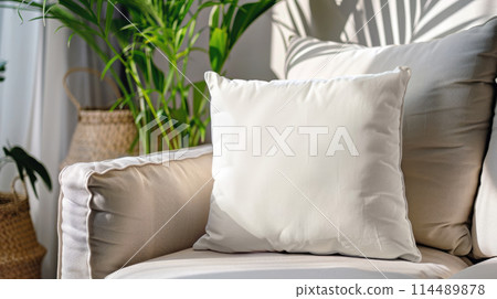 Blank white pillow on a couch. Closeup mockup template. Cozy interior 114489878
