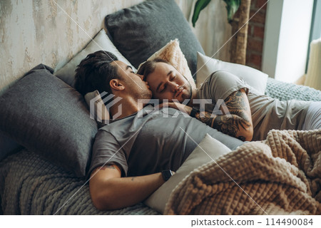 A homosexual couple on bed in studio with loft interior A homosexual couple on bed in studio with loft interior 114490084