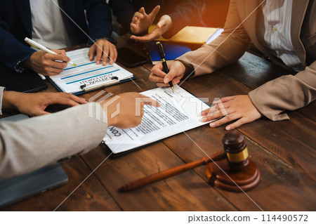 Teamwork of business lawyer meeting working hard about legal legislation in courtroom to help their customer.. Teamwork of business lawyer meeting working hard about legal legislation in courtroom to help their customer.. 114490572