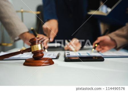 Teamwork of business lawyer meeting working hard about legal legislation in courtroom to help their customer.. 114490576