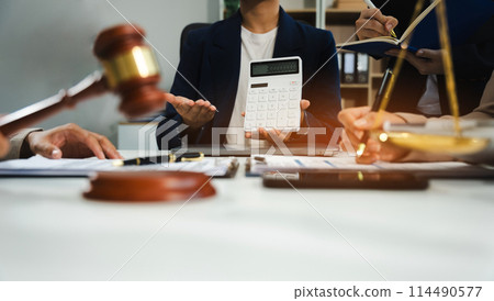 Teamwork of business lawyer meeting working hard about legal legislation in courtroom to help their customer.. 114490577