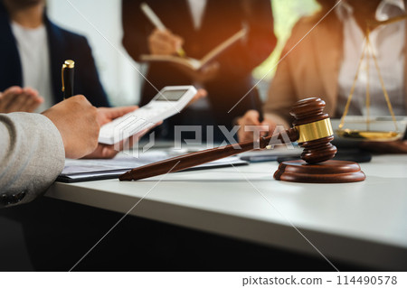 Teamwork of business lawyer meeting working hard about legal legislation in courtroom to help their customer.. 114490578