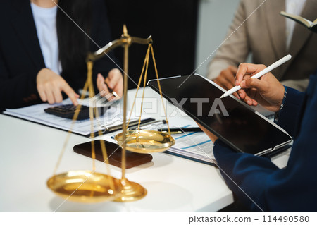 Teamwork of business lawyer meeting working hard about legal legislation in courtroom to help their customer.. 114490580