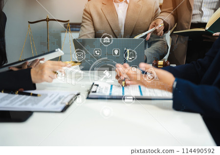 Teamwork of business lawyer meeting working hard about legal legislation in courtroom to help their customer.. 114490592