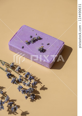 Lavender soap on beige background with copy space for your text. Advertisement template mock up. Skincare homemade natural cosmetic concept. Organic dry lavender flower Lavender soap on beige background with copy space for your text. Advertisement template mock up. Skincare homemade natural cosmetic concept. Organic dry lavender flower 114490631