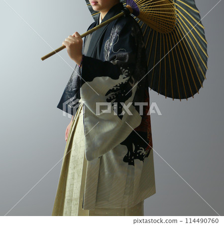 A man in a kimono holding an umbrella A man in a kimono holding an umbrella 114490760