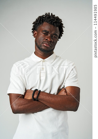 Man in White Shirt With Arms Crossed 114491985