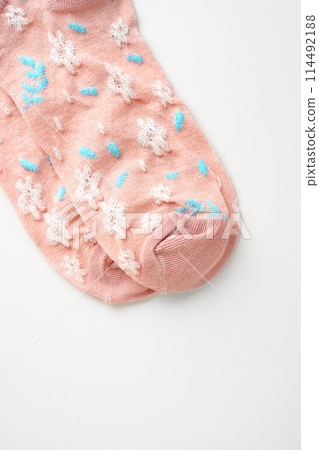 Pink socks with pattern on white background Pink socks with pattern on white background 114492188