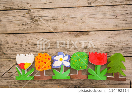 Kids craft trees and flowers out of recycling toilet paper roll, zero waste concept. 114492314