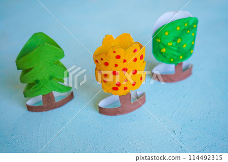 Kids craft trees out of recycling toilet paper roll, zero waste concept. Kids craft trees out of recycling toilet paper roll, zero waste concept. 114492315