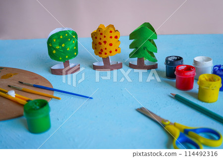 Kids craft trees out of recycling toilet paper roll, zero waste concept. 114492316