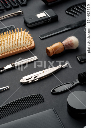 Variety of Hair Styling Tools and Accessories Displayed on a Dark Background Variety of Hair Styling Tools and Accessories Displayed on a Dark Background 114492319