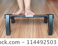Woman massage with foot rest under desk for relieve plantar fasciitis at home 114492503