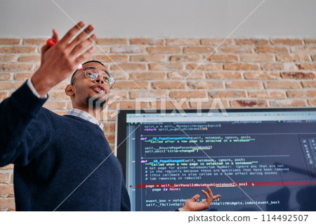 African American businessman delivers a compelling presentation of his business strategy to his colleagues, fostering collaboration and forward thinking African American businessman delivers a compelling presentation of his business strategy to his colleagues, fostering collaboration and forward thinking 114492507