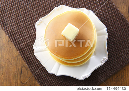 3-tiered pancakes topped with butter 114494480