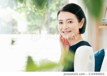 Middle-aged woman touching her cheek 114494803