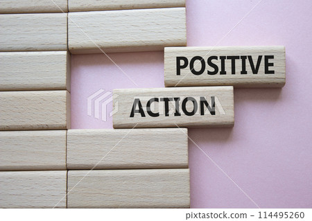 Positive action symbol. Concept words Positive action on wooden blocks. Beautiful pink background. Business and Positive action concept. Copy space. Positive action symbol. Concept words Positive action on wooden blocks. Beautiful pink background. Business and Positive action concept. Copy space. 114495260
