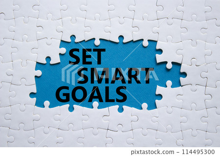 Set smart goals symbol. Concept words Set smart goals on white puzzle. Beautiful blue background. Business and Set smart goals concept. Copy space. Set smart goals symbol. Concept words Set smart goals on white puzzle. Beautiful blue background. Business and Set smart goals concept. Copy space. 114495300
