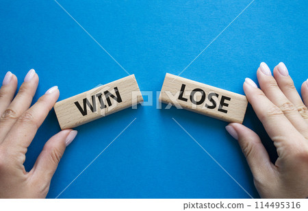 Win or Lose symbol. Concept word Win or Lose on wooden blocks. Businessman hand. Beautiful blue background. Business and Win or Lose concept. Copy space Win or Lose symbol. Concept word Win or Lose on wooden blocks. Businessman hand. Beautiful blue background. Business and Win or Lose concept. Copy space 114495316