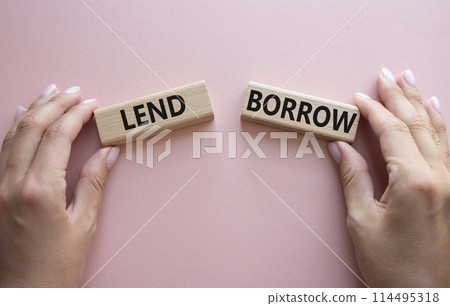 Lend or Borrow symbol. Concept word Lend or Borrow on wooden blocks. Businessman hand. Beautiful pink background. Business and Lend or Borrow concept. Copy space 114495318