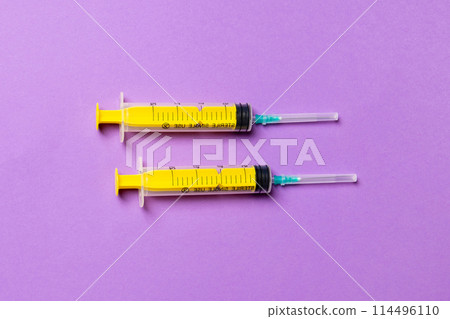 Top view of medical syringes on colorful background. Health care concept with copy space Top view of medical syringes on colorful background. Health care concept with copy space 114496110