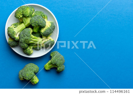 broccoli of fresh green broccoli in bowl over coloredbackground. , close up. Fresh vegetable broccoli of fresh green broccoli in bowl over coloredbackground. , close up. Fresh vegetable 114496161