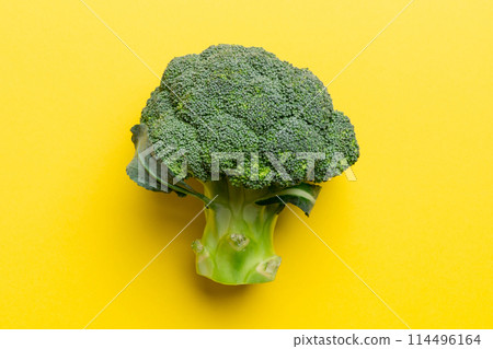 green fresh broccoli background close up on colored table. Vegetables for diet and healthy eating. Organic food green fresh broccoli background close up on colored table. Vegetables for diet and healthy eating. Organic food 114496164