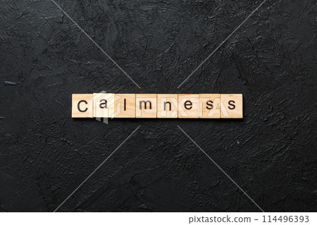 calmness word written on wood block. calmness text on cement table for your desing, concept calmness word written on wood block. calmness text on cement table for your desing, concept 114496393
